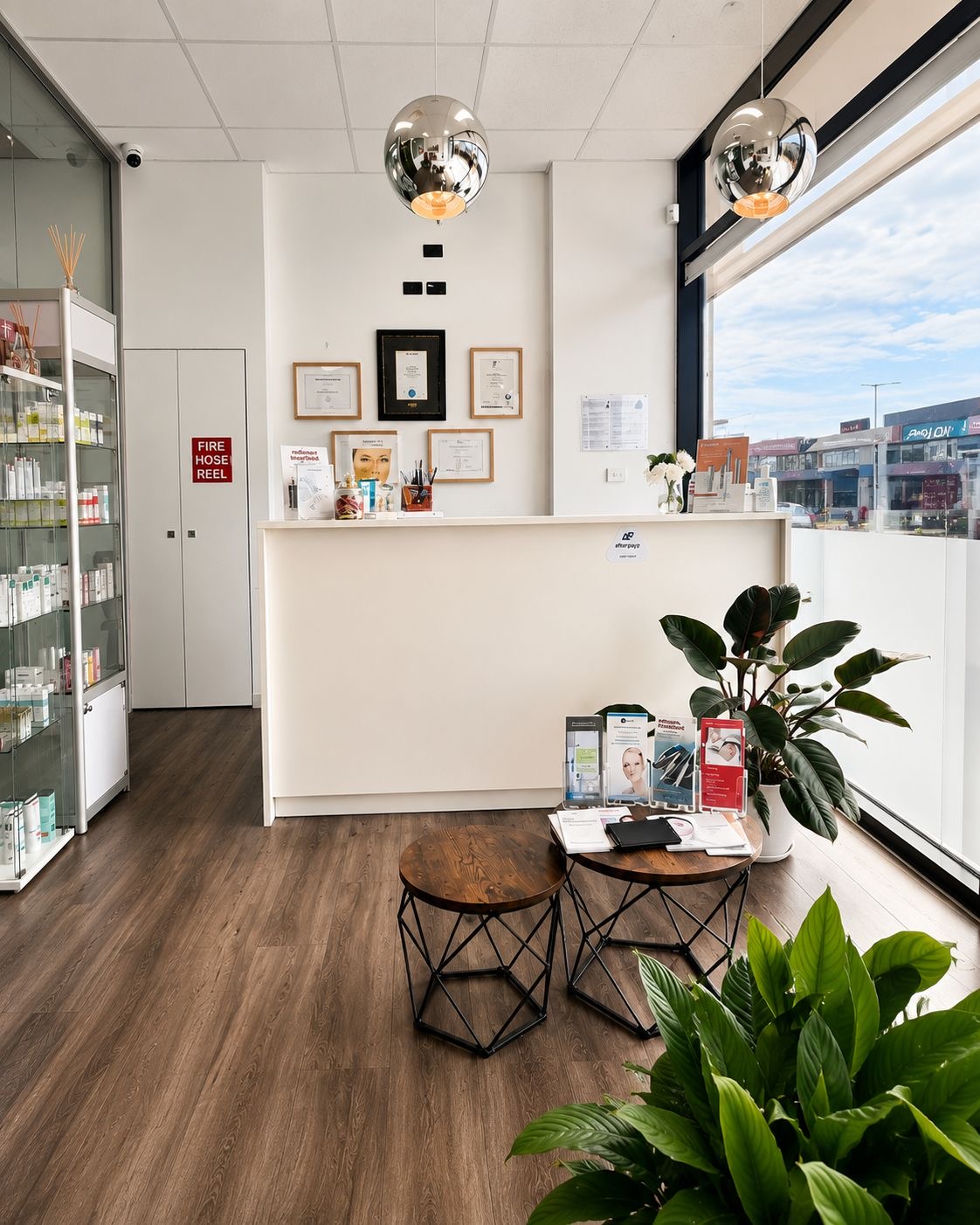 The DermaMedica reception and retail area, with skincare on display and natural light from the street-facing window